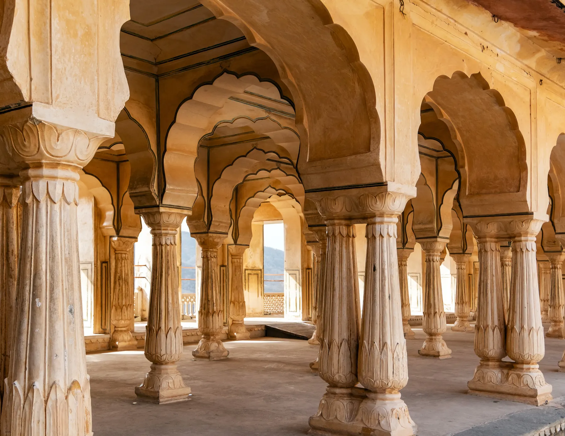 Sandstone colonnade with scalloped arches