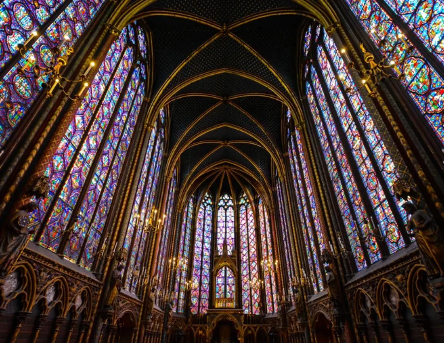 Chapel interior with floor-to-ceiling stained glass windows
