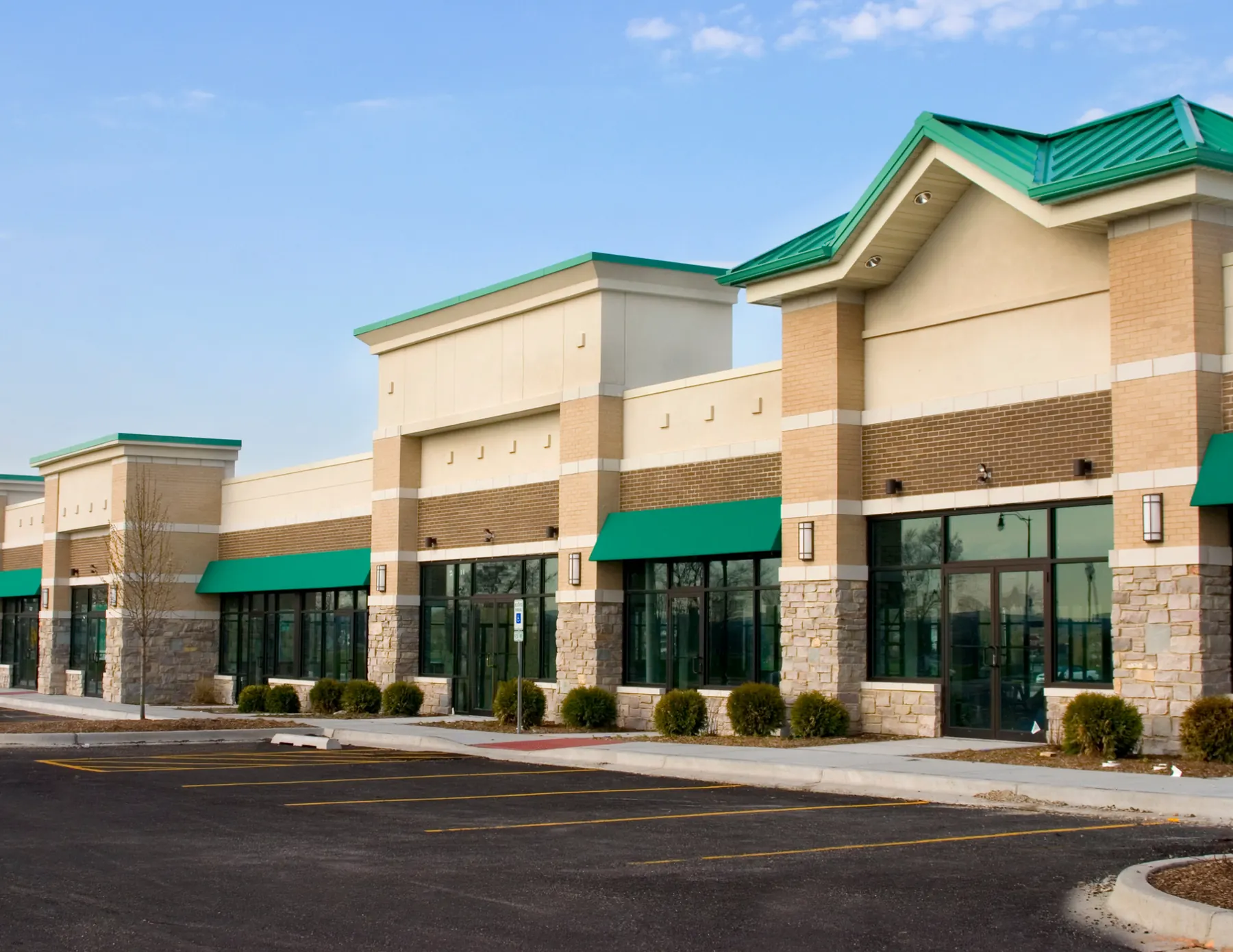 Suburban retail center with gabled entries and green roofs